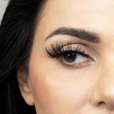 Suntarah Beauty 3D Faux Mink False Strip Eyelash in Style F-106.  Close up of young woman wearing lash looking to the side.  False eyelash has cat eye like look.